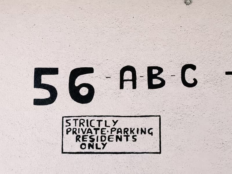Hand-painted ‘strictly private parking, residents only’ notice on a wall